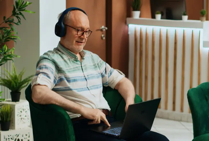 Older adult using laptop while sitting